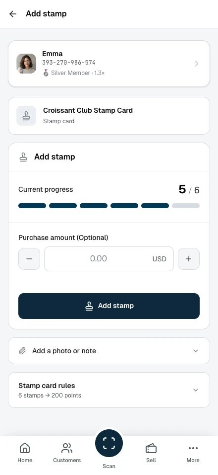 Staff add a stamp to a customer’s card.